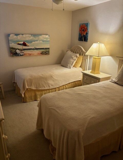 Cozy bedroom with two single beds and warm lighting.