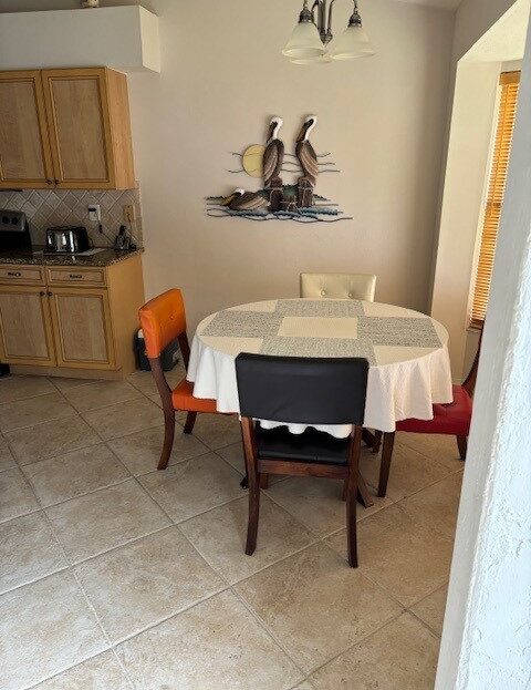 Dining table with mixed chairs in a cozy kitchen corner.