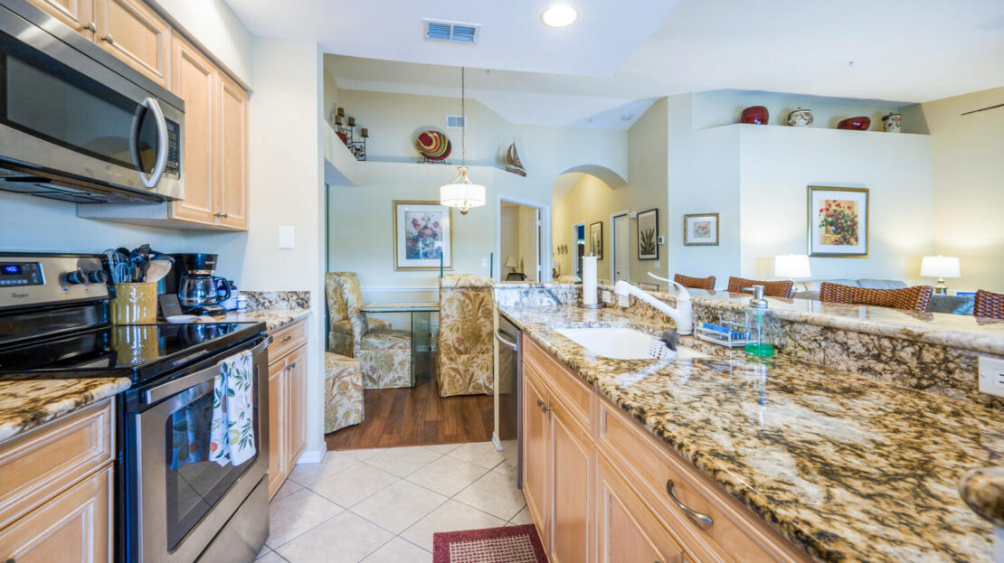 Spacious kitchen with granite countertops and wooden cabinets.