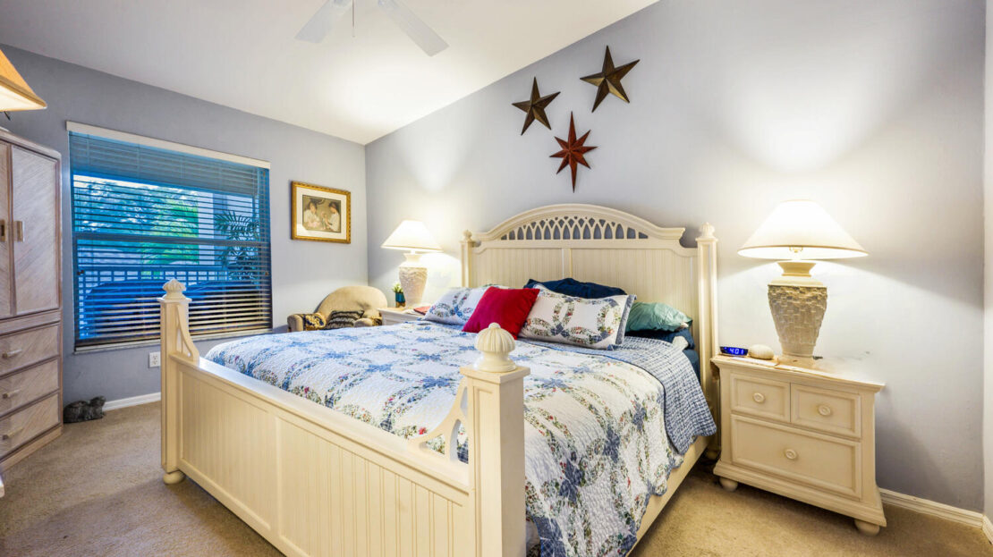 Cozy bedroom with a large bed, floral bedding, and star wall decor.