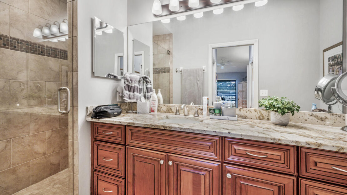 Elegant bathroom vanity with granite countertop and wooden cabinets.