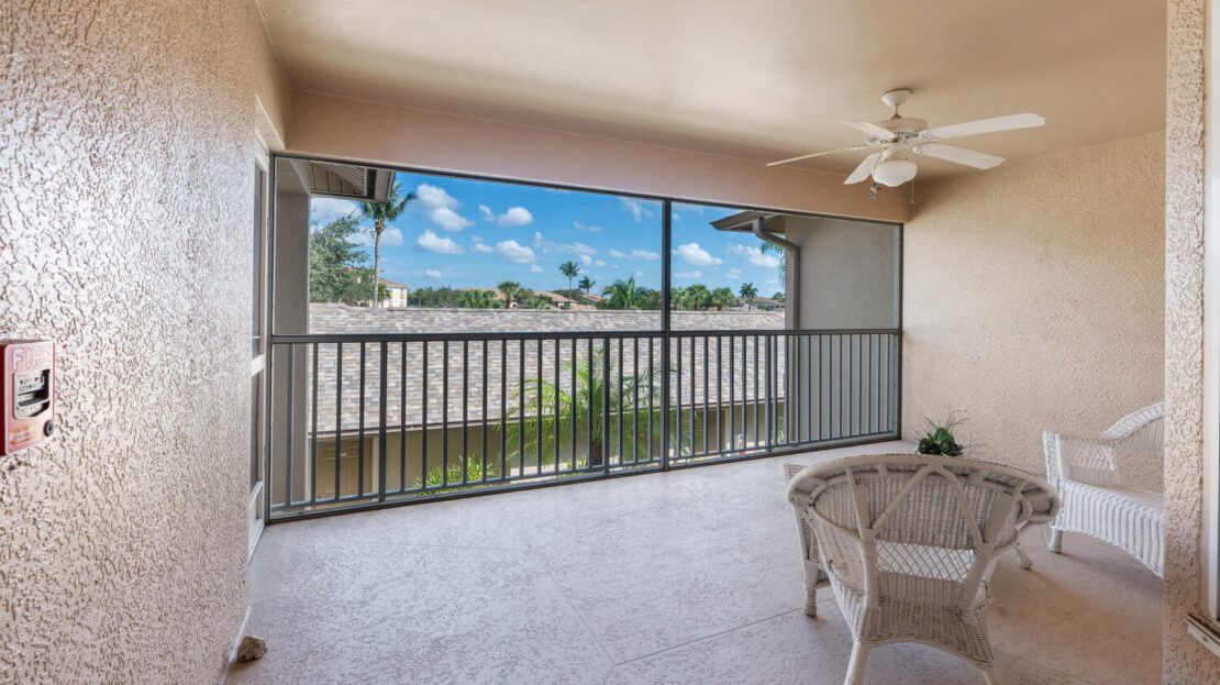 Bright balcony with a scenic water view and comfortable seating.