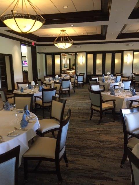 Elegant dining room with neatly set tables and soft lighting.