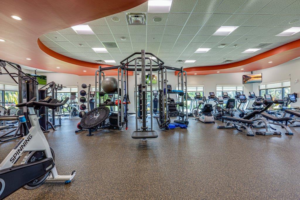 A spacious modern gym with various workout machines and equipment.