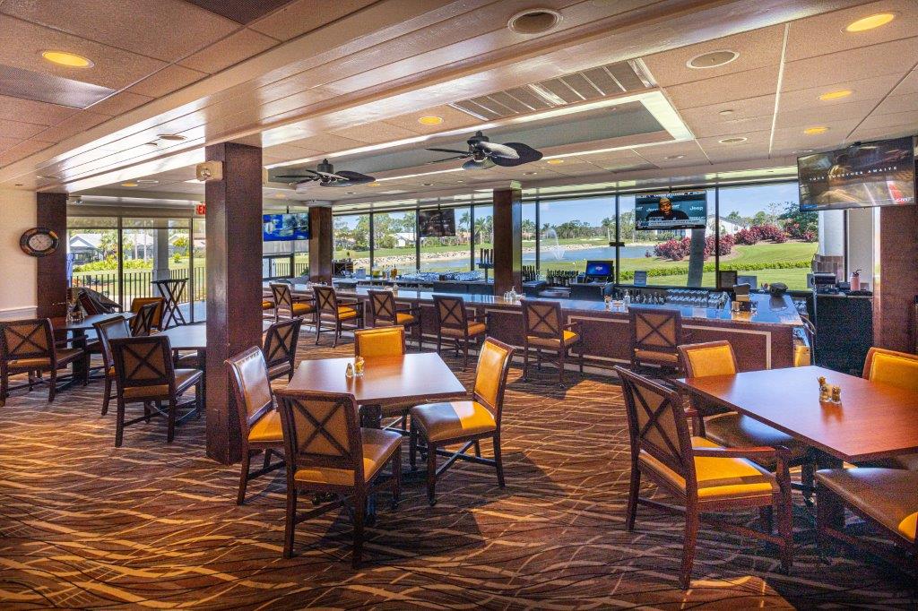 Spacious dining area with wooden accents and large windows overlooking a golf course.