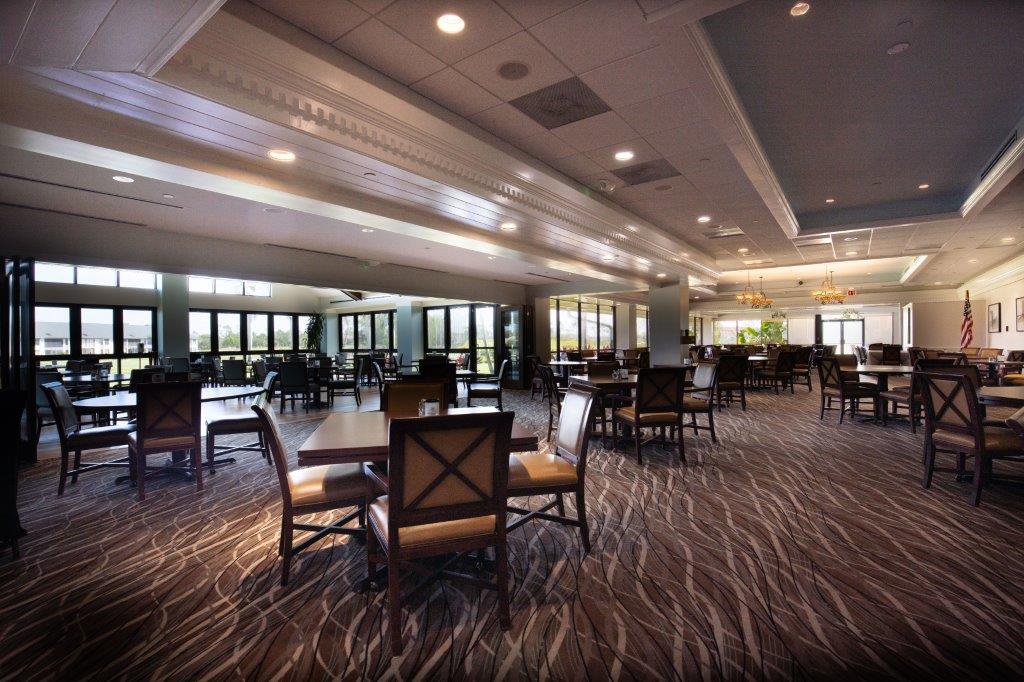 Spacious dining area with modern decor and large windows.