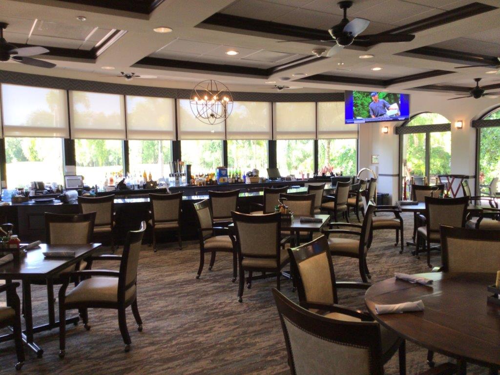 Spacious, well-lit dining area with elegant chairs and large windows.