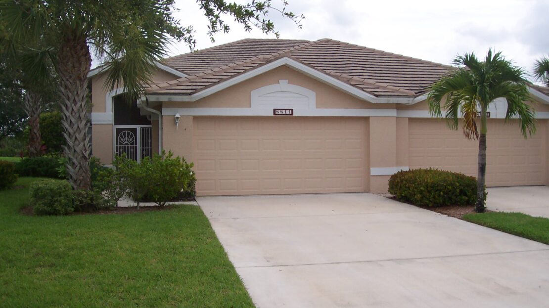A suburban house with a double garage and a driveway.