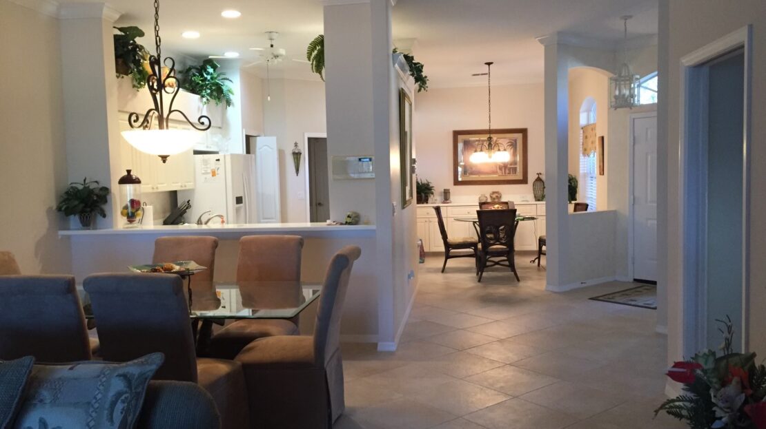 Modern open-concept living and dining area with neutral tones and elegant decor.