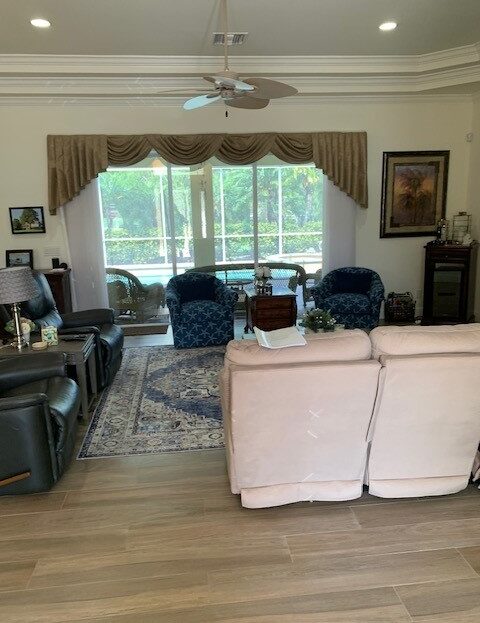 Cozy living room with plush sofas and large windows letting in natural light.