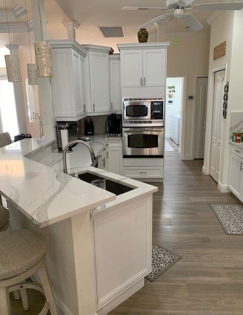 Bright modern kitchen with white cabinetry and island.