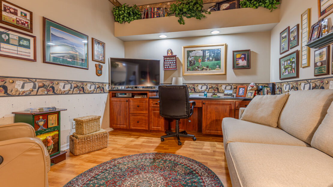 Cozy home office with wooden furniture and decorative art.