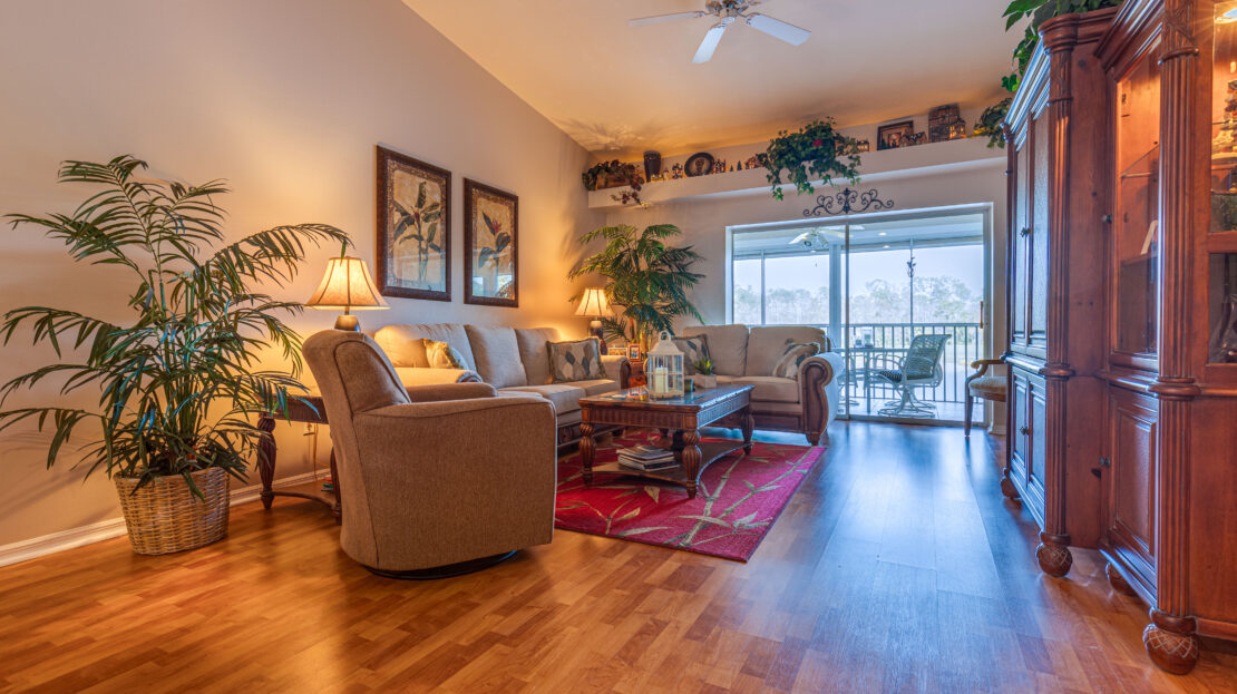 Cozy living room with warm lighting and wooden flooring.
