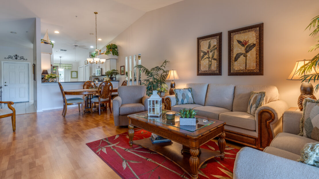 Cozy living room with classic wooden furniture and warm lighting.