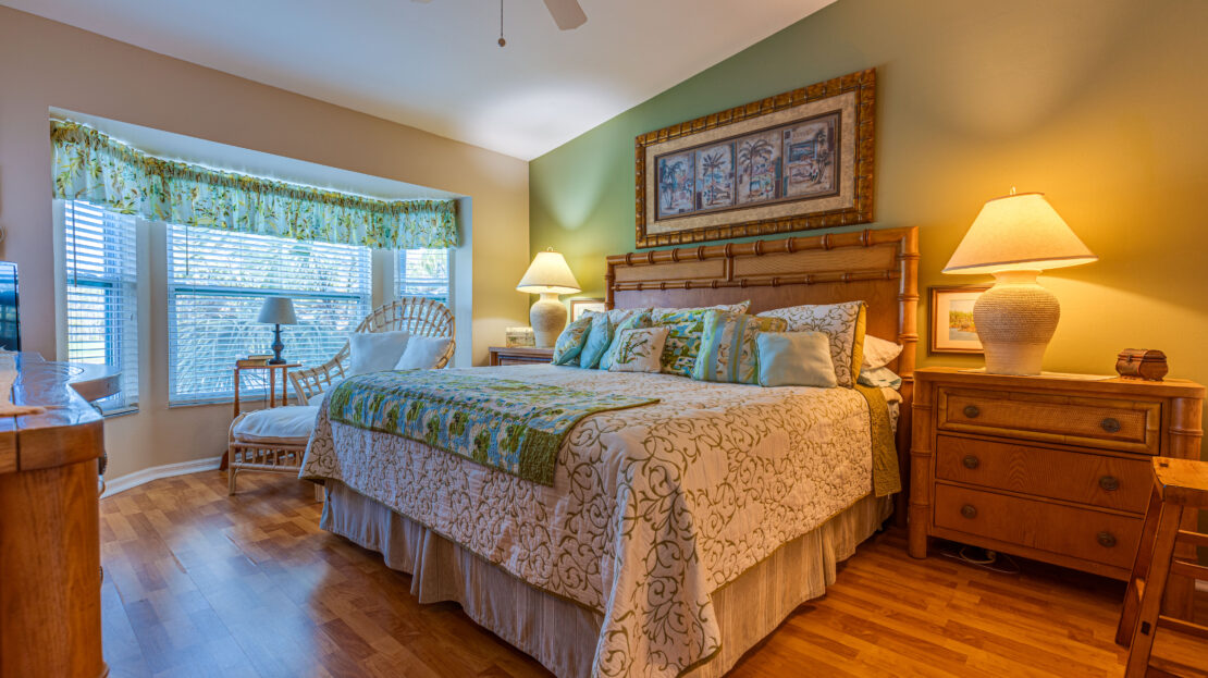 Cozy bedroom with green accents and natural light.