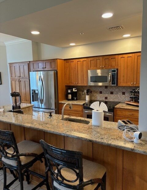 Modern kitchen with wooden cabinets and granite countertops.
