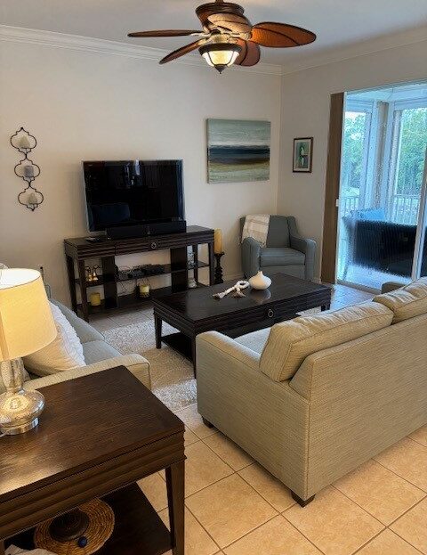 Cozy living room with beige sofa, armchair, and TV setup.