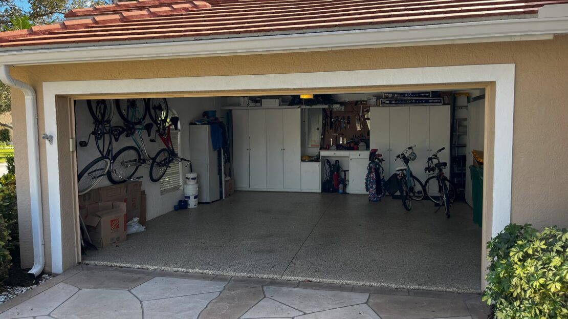 A clean garage with bicycles and storage items neatly arranged.