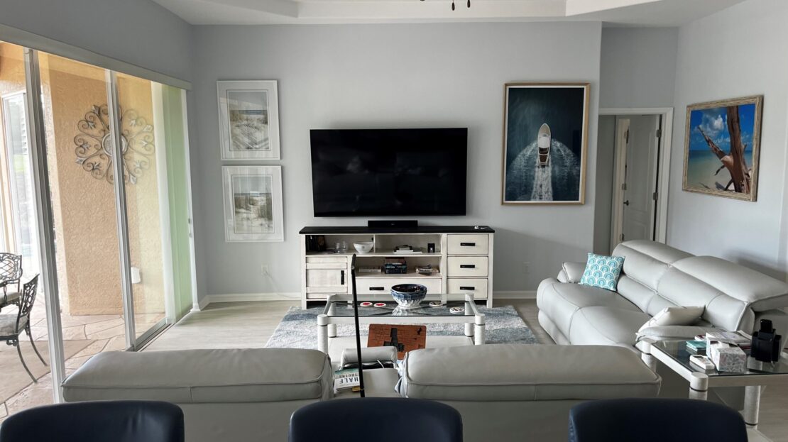 Modern living room with gray furniture and a wall-mounted TV.