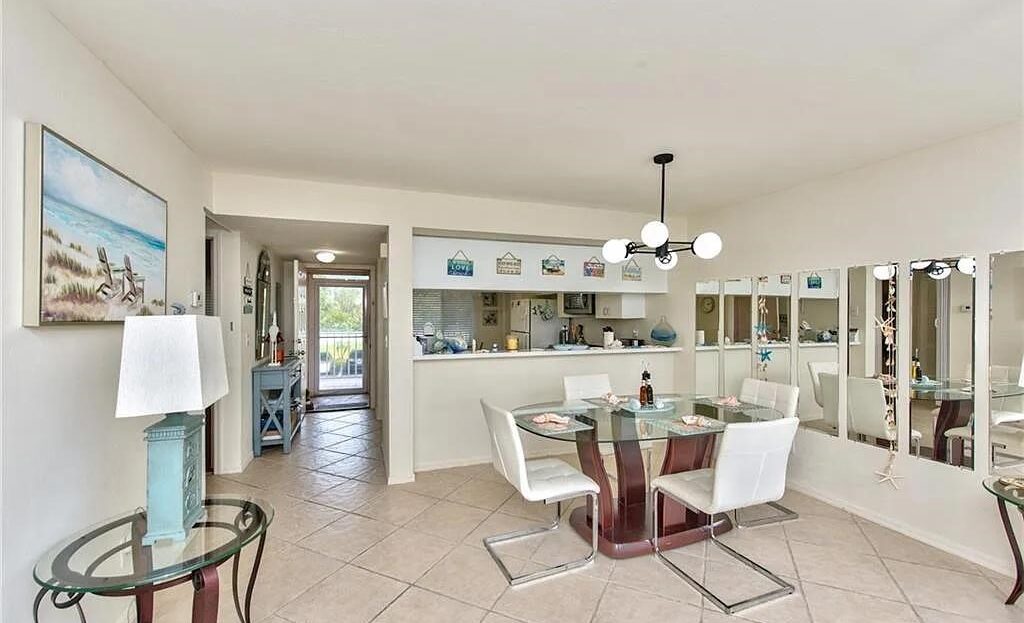 Bright dining area with modern furniture and hanging lights.