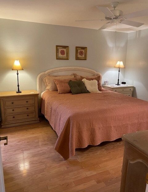 Cozy bedroom with warm lighting and a neatly made bed.