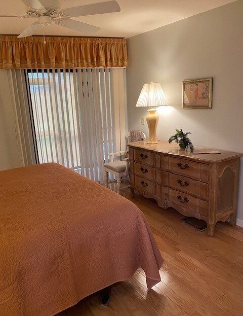 Cozy bedroom with wooden dresser and warm lighting.