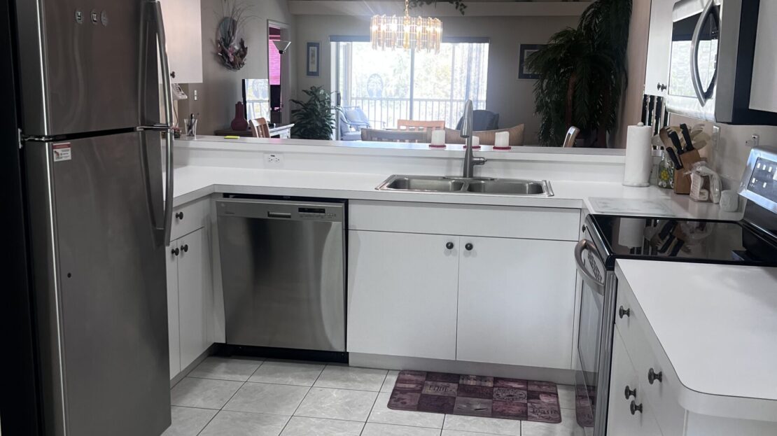 Bright, clean kitchen with modern appliances and white cabinetry.