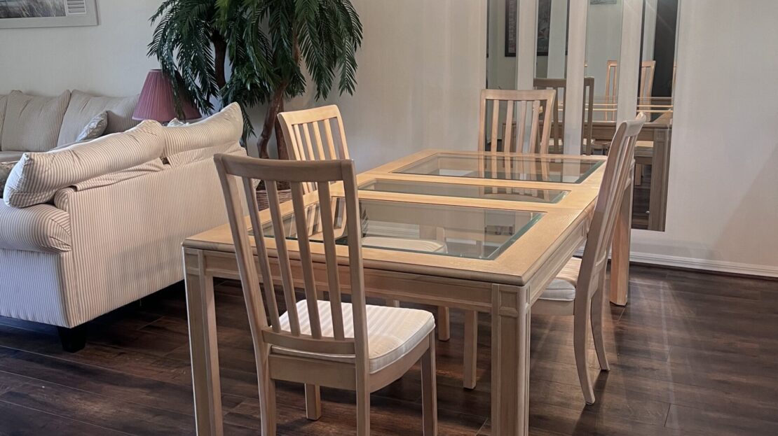 Elegant dining table with wooden chairs in a cozy living area.