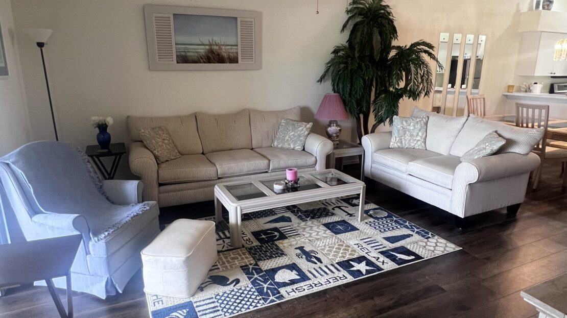 Cozy living room with neutral-toned sofas and a patterned rug.