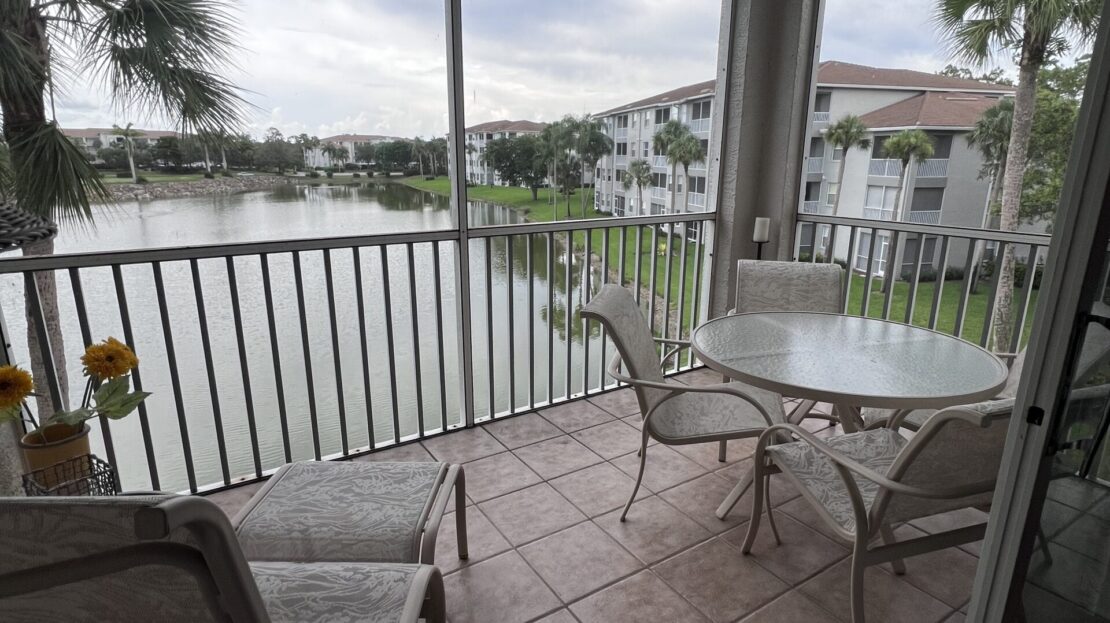 Cozy patio with lake view and outdoor seating.