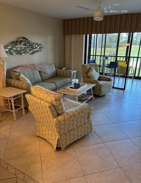 Cozy living room with patterned armchairs and natural light from sliding glass doors.
