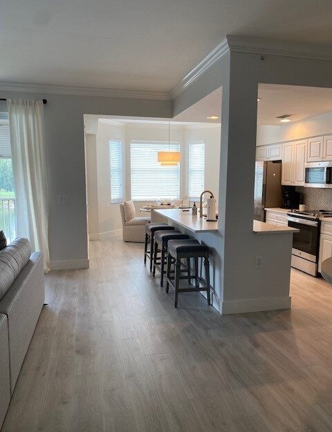 Modern kitchen with bar seating and a cozy dining area.
