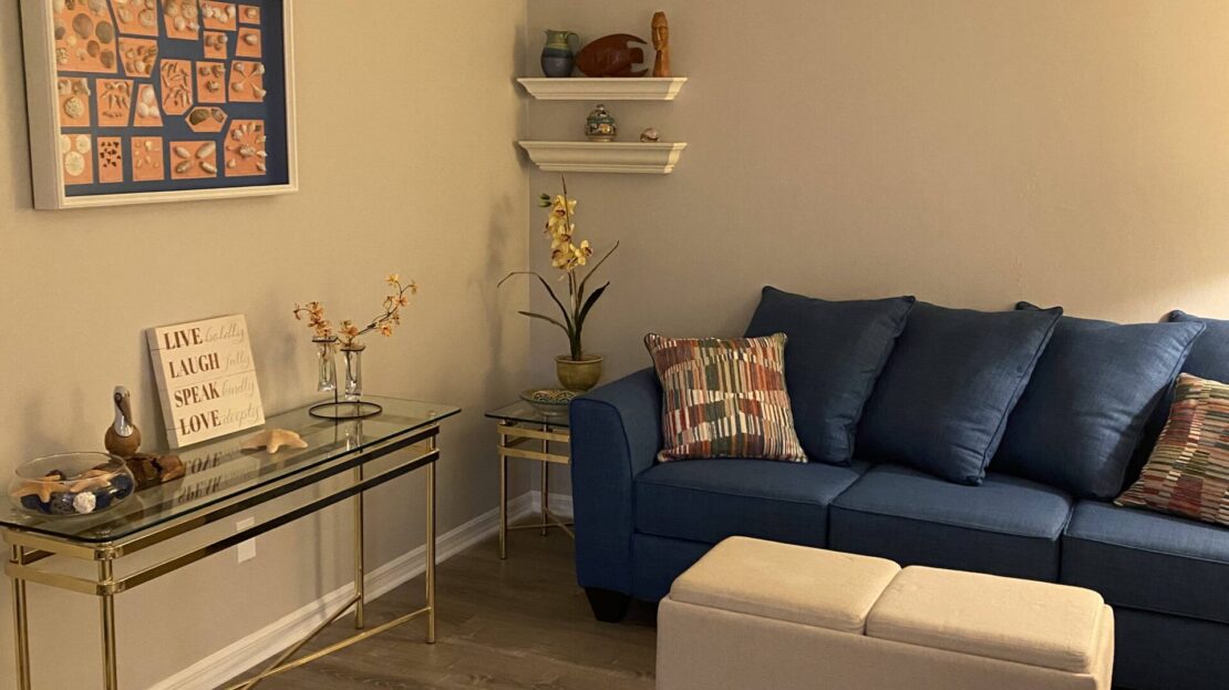 Cozy living room with a blue sofa and decorative accents.
