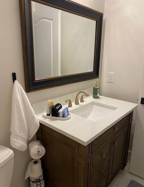 Elegant bathroom sink area with a large mirror and neatly arranged toiletries.