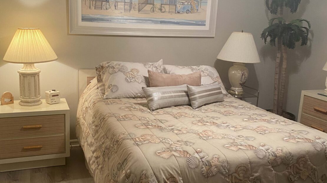 Cozy bedroom with warm lighting and neutral decor.