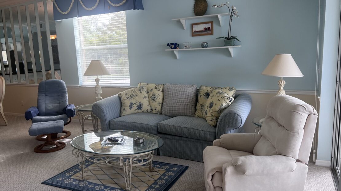 Cozy living room with a blue sofa and soft armchairs.