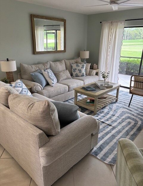 Cozy living room with beige sectional sofa and large window.