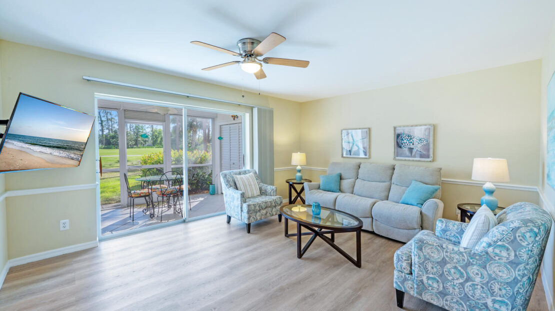 Bright living room with large windows and comfortable seating.