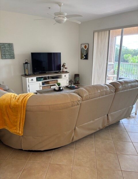 Cozy living room with beige sectional sofa and TV setup.
