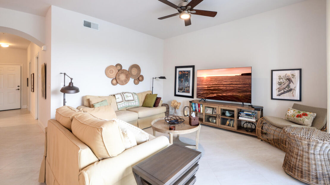 Bright, cozy living room with beige sofas and modern decor.