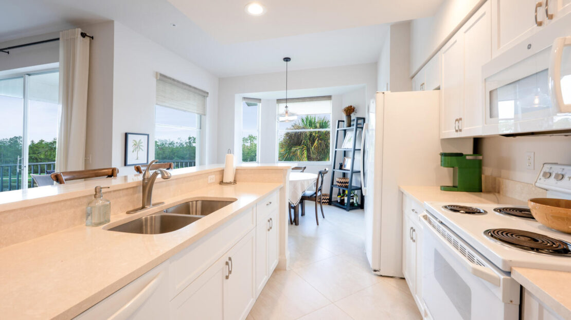 Bright modern kitchen with white cabinetry and a cozy dining nook.