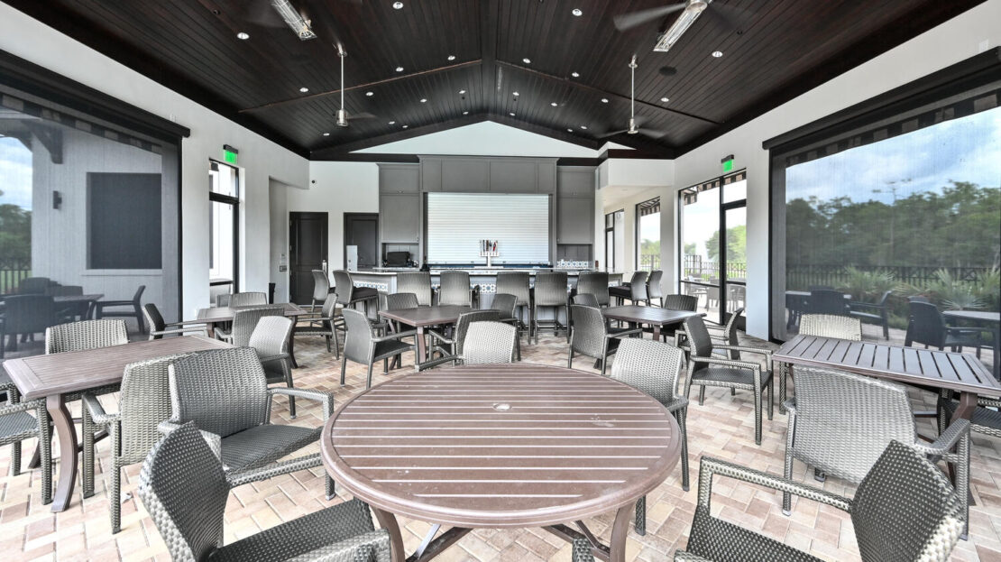 Modern indoor seating area with round and rectangular tables and chairs.