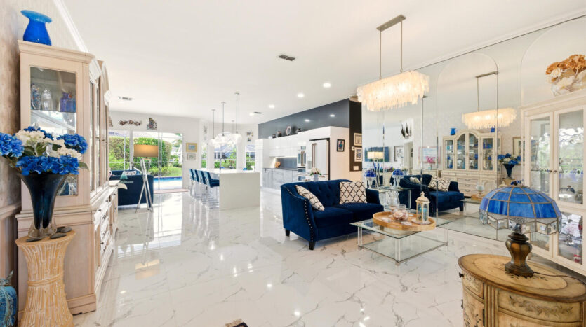 Luxurious open-concept living and dining area with modern furnishings and marble floors.