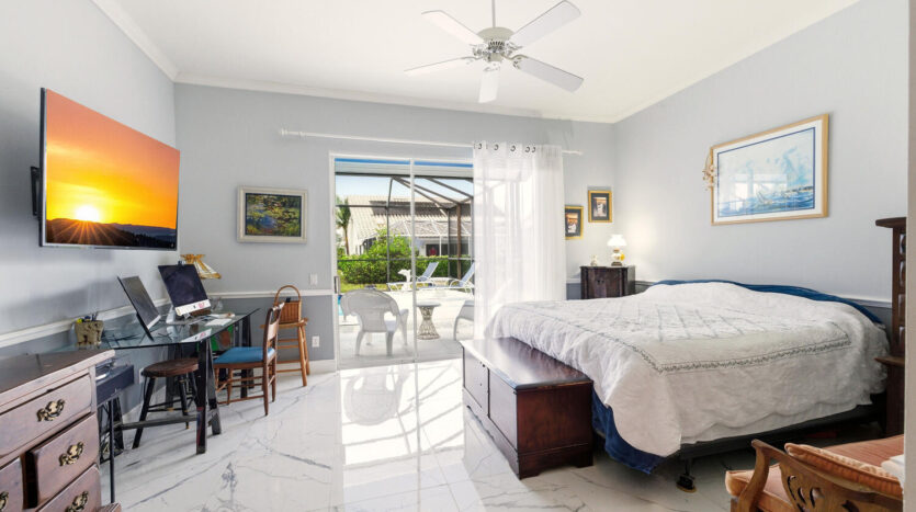 Bright bedroom with large windows and modern decor.