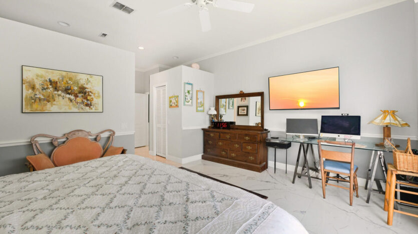 Cozy bedroom with classic wooden furniture and modern workspace.