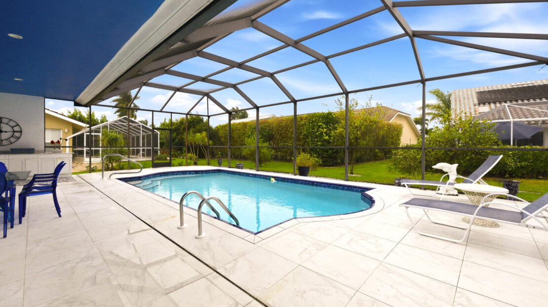 Bright indoor pool area with clear water and garden views.