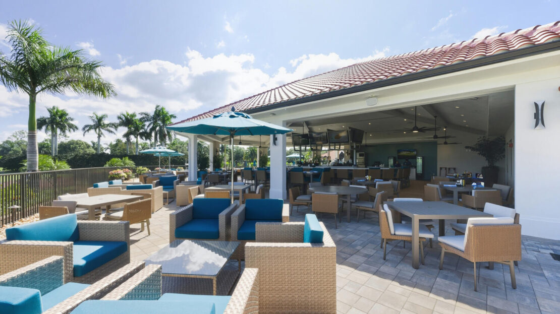 Spacious outdoor lounge with modern seating under a clear blue sky.