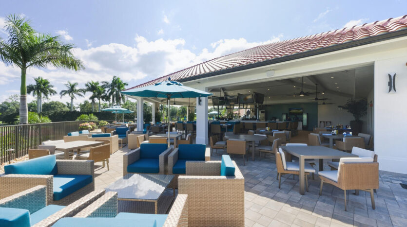 Open-air lounge with comfortable seating and a blue sky.